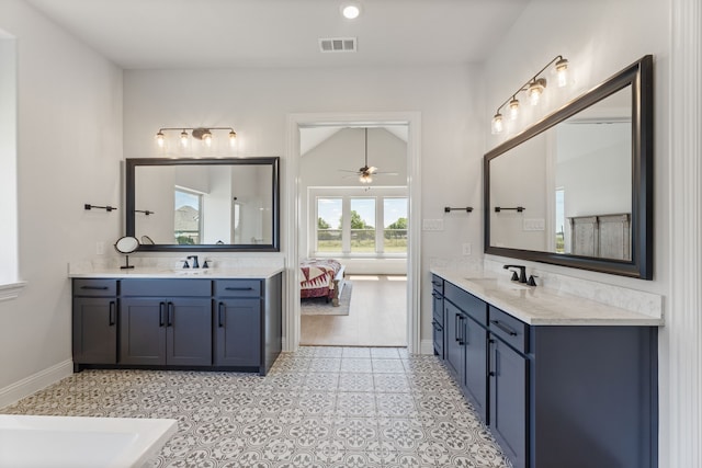 bathroom featuring vanity, vaulted ceiling, and ceiling fan