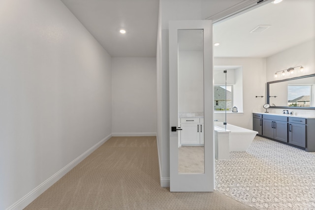 bathroom featuring vanity and a bath