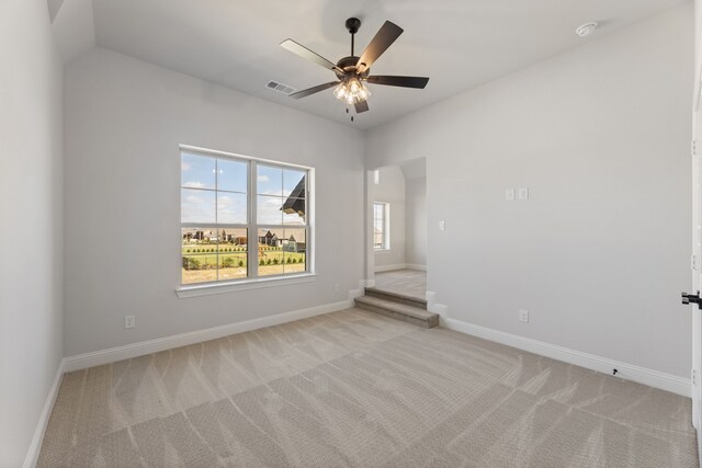 spare room featuring ceiling fan and light colored carpet