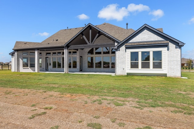 back of property featuring a lawn and a patio