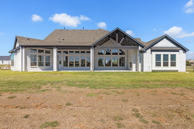 rear view of property featuring a lawn and a patio