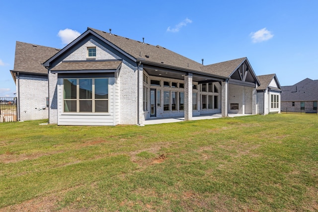 back of house featuring a yard and a patio