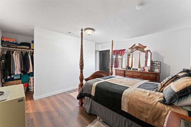 bedroom with a closet and dark wood-type flooring