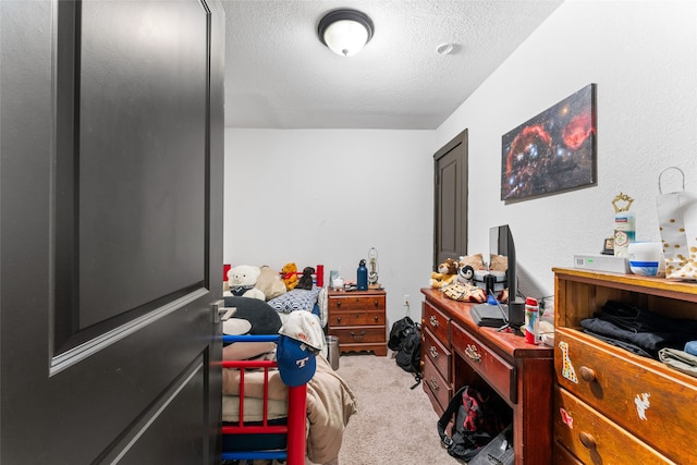 carpeted bedroom with a textured ceiling