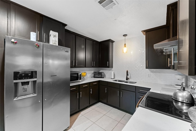 kitchen featuring hanging light fixtures, sink, light tile patterned floors, range hood, and stainless steel appliances