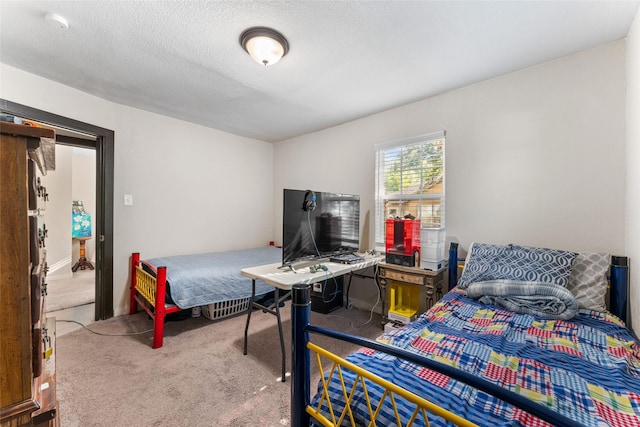 bedroom with a textured ceiling and carpet