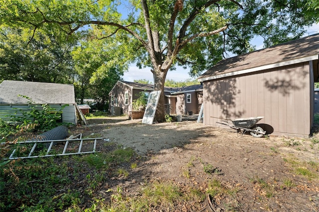 view of yard featuring a storage shed and central AC