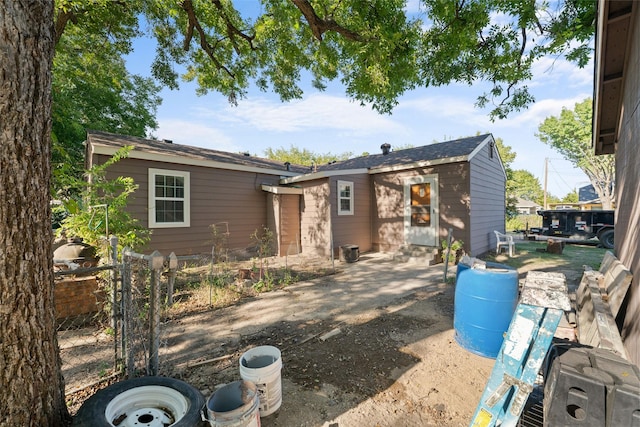 back of house with an outbuilding