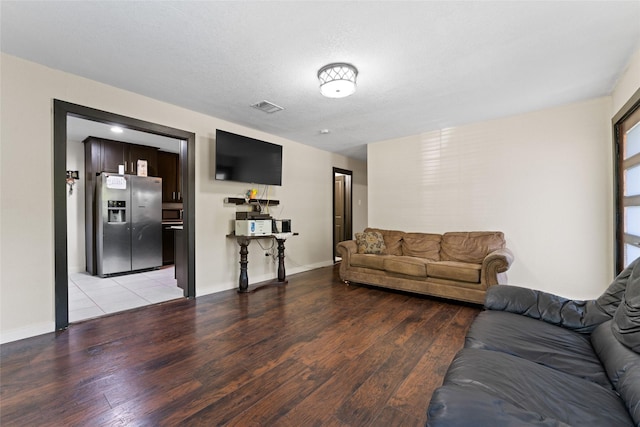 living room with light hardwood / wood-style floors and a textured ceiling