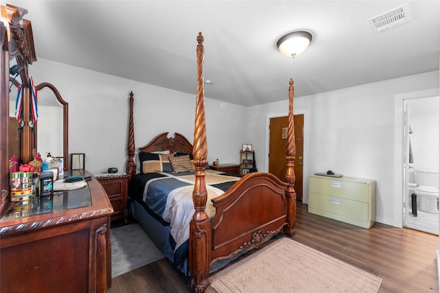 bedroom featuring dark hardwood / wood-style floors and ensuite bathroom