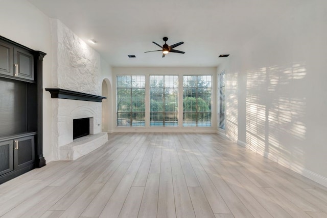 1005 Barre Meadow Ln, Mckinney, TX 75071 - unfurnished living room with light wood finished floors, a fireplace, visible vents, baseboards, and ceiling fan