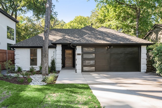 view of front of property with a garage and a front lawn