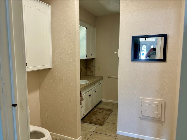 bathroom featuring vanity, toilet, and tile patterned floors