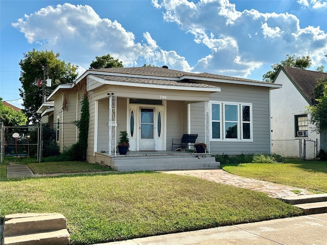 bungalow-style home featuring a front lawn