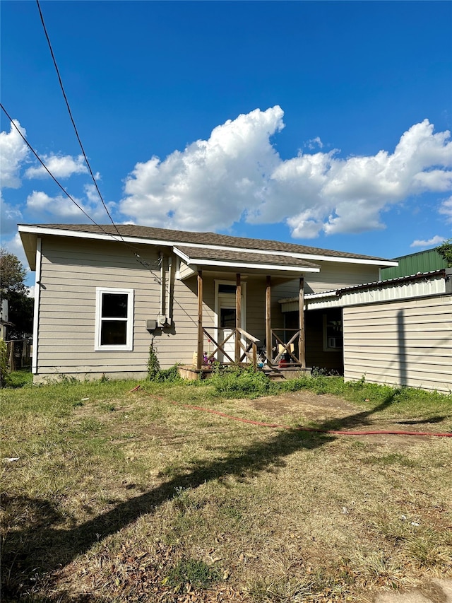 back of property featuring a lawn