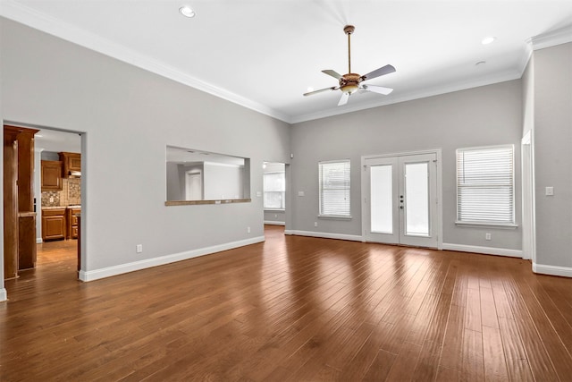 interior space featuring wood-type flooring, ornamental molding, and ceiling fan