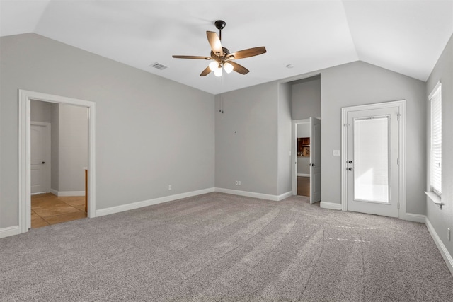 unfurnished bedroom with light carpet, vaulted ceiling, and ceiling fan