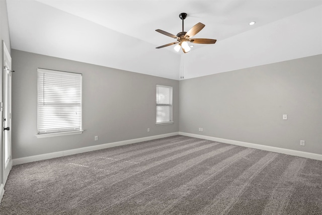 spare room featuring ceiling fan, lofted ceiling, and carpet