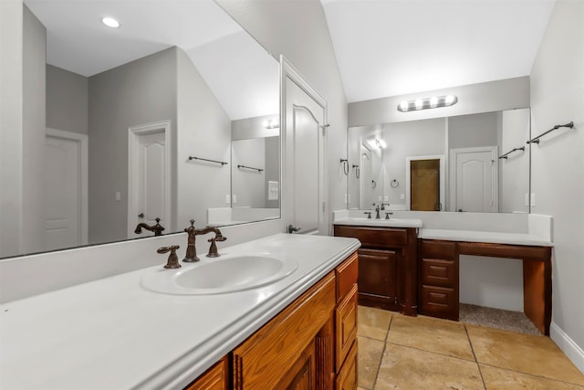 bathroom with lofted ceiling, vanity, and tile patterned floors