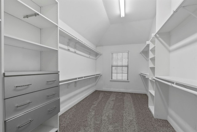 walk in closet featuring dark colored carpet and vaulted ceiling