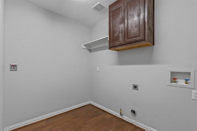 laundry area featuring washer hookup, hardwood / wood-style flooring, hookup for an electric dryer, cabinets, and gas dryer hookup