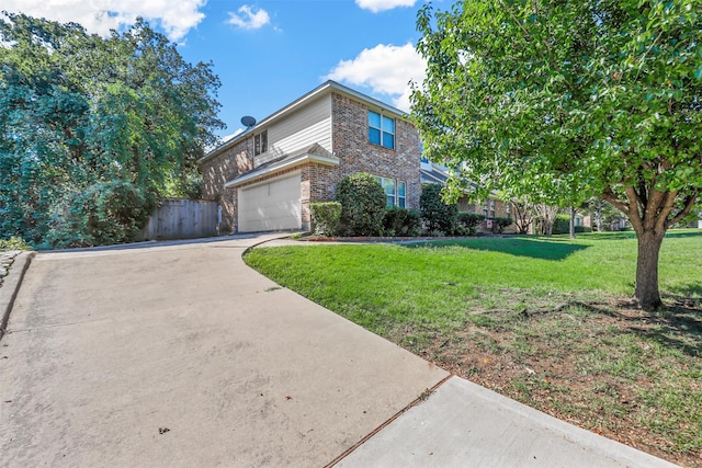 view of front of property with a front yard and a garage