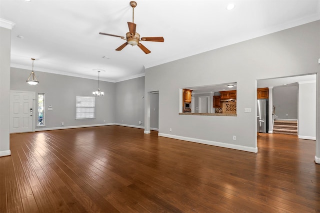 unfurnished living room featuring ceiling fan with notable chandelier, ornamental molding, and dark hardwood / wood-style flooring