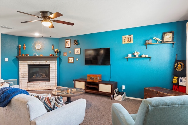 carpeted living room featuring ceiling fan and a brick fireplace