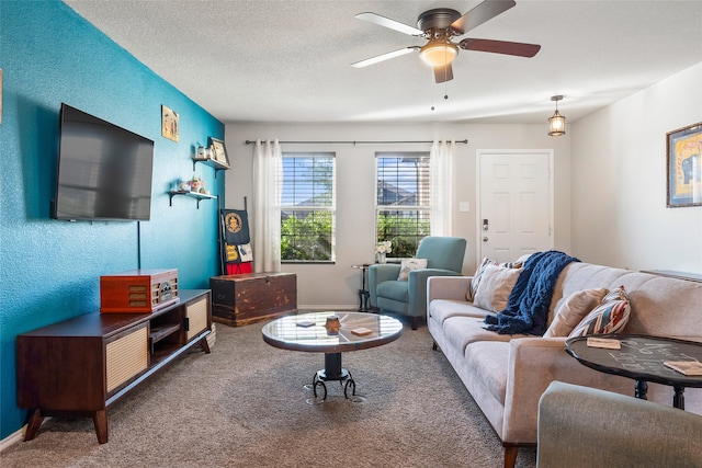 living room with carpet flooring, ceiling fan, and a textured ceiling