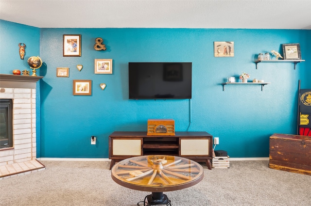 living room with carpet floors and a brick fireplace