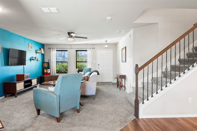 living room featuring hardwood / wood-style floors and ceiling fan