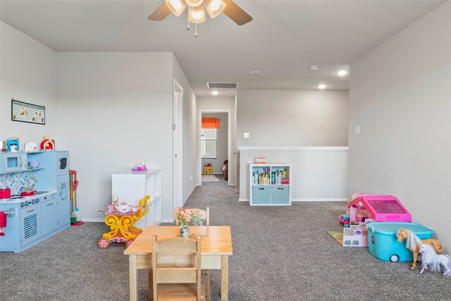 playroom featuring ceiling fan and carpet