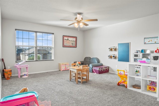 rec room featuring carpet and ceiling fan