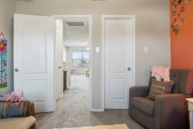 living area featuring ceiling fan and light carpet