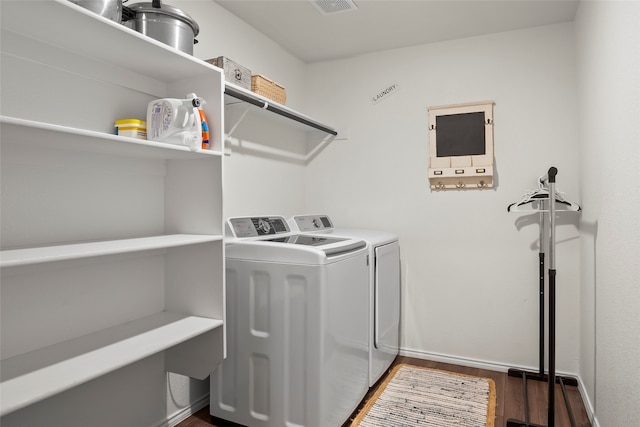 laundry room with dark hardwood / wood-style flooring and separate washer and dryer