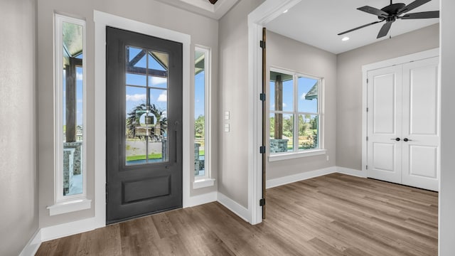 foyer entrance with ceiling fan and light hardwood / wood-style flooring