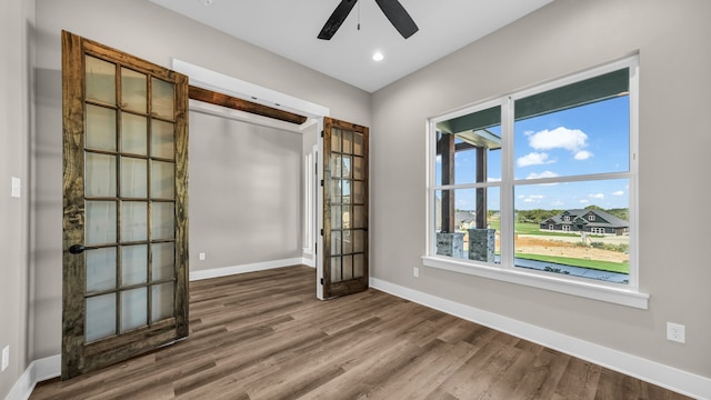 spare room with ceiling fan and hardwood / wood-style flooring