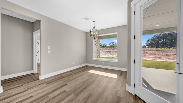 interior space with a chandelier and light hardwood / wood-style floors