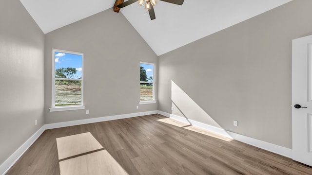 unfurnished room with ceiling fan, beamed ceiling, hardwood / wood-style floors, and high vaulted ceiling