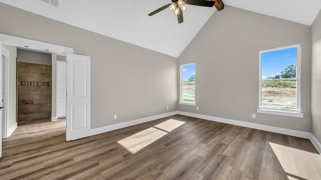 unfurnished bedroom featuring ceiling fan, hardwood / wood-style flooring, beam ceiling, and high vaulted ceiling