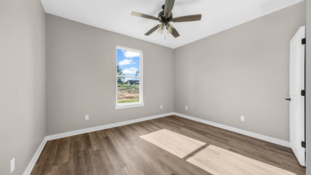 spare room with wood-type flooring and ceiling fan