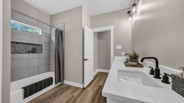 bathroom with hardwood / wood-style floors, vanity, and curtained shower