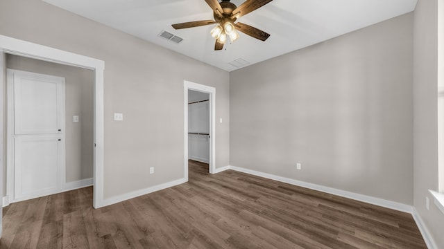 unfurnished bedroom with a closet, ceiling fan, and dark wood-type flooring