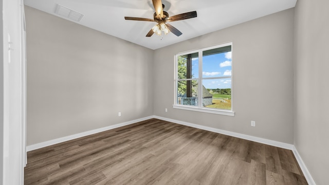 unfurnished room with ceiling fan and wood-type flooring