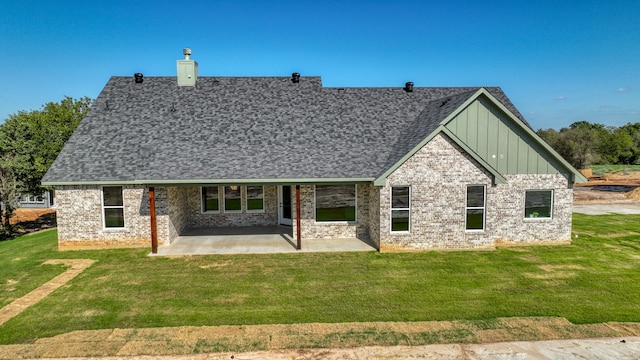 view of front of property with a patio and a front lawn