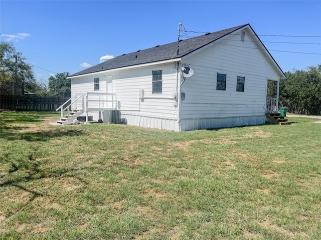 back of house with a yard and cooling unit