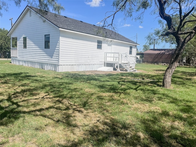 back of property featuring a yard