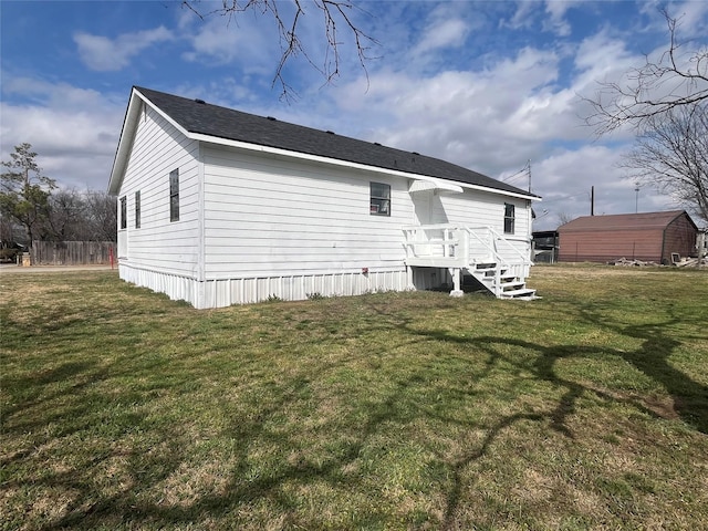 rear view of property with a lawn