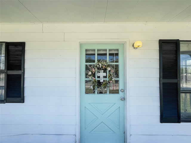 doorway to property with concrete block siding