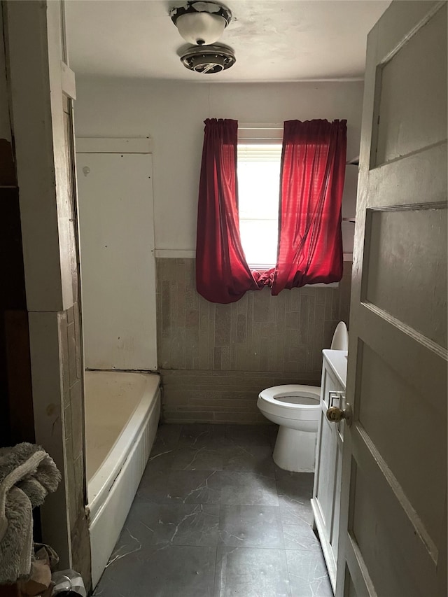 full bathroom featuring tile walls, vanity, toilet, and separate shower and tub